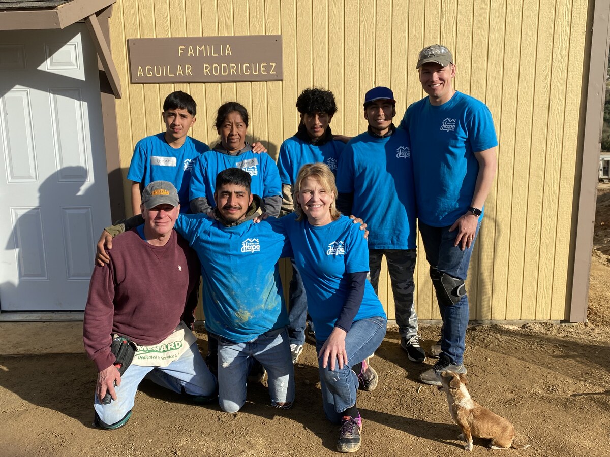 Jose, his mother and his brothers, with their new house.